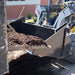 4 in 1 skid steer bucket being used on skid steer