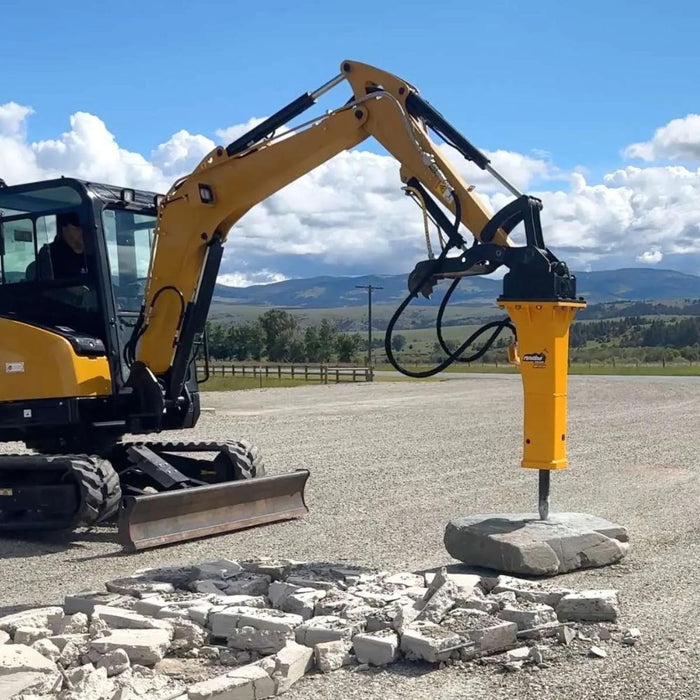 montana mini excavator hydraulic hammer breaking concrete slab side view