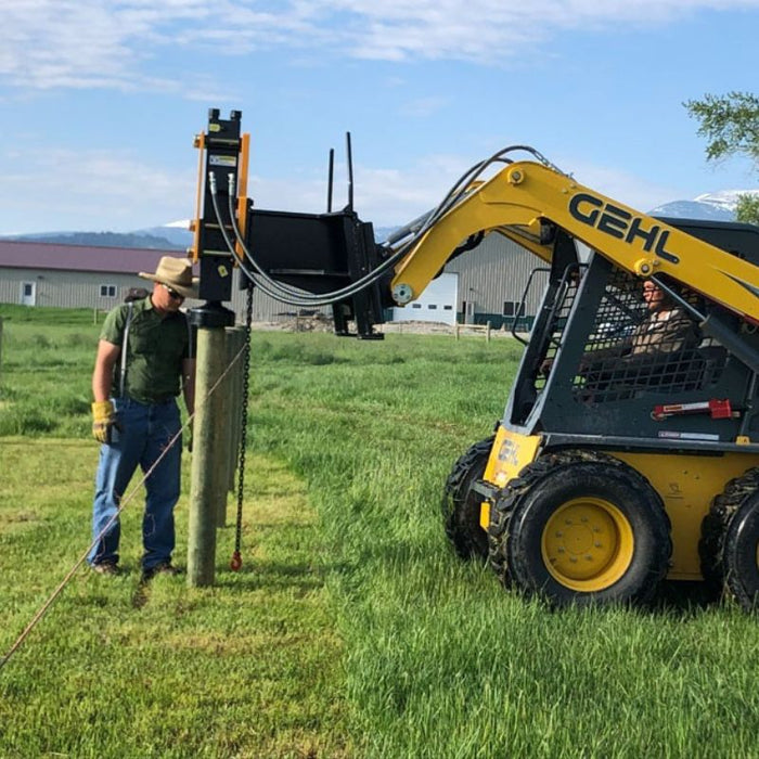 montana post driver driving wooden posts side view