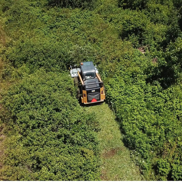 flail mower skid steer in forest