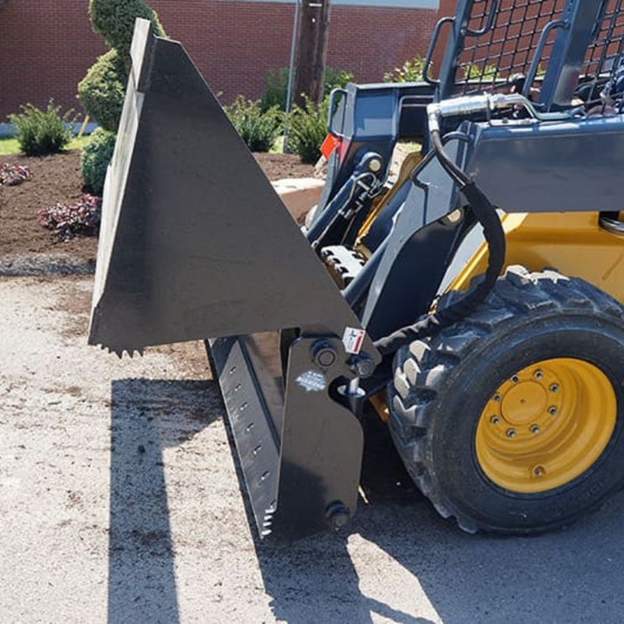 four in one bucket attached to skid steer side view