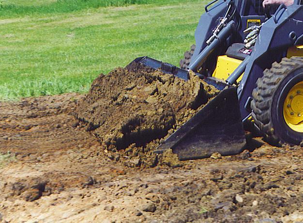 heavy duty skid steer in action with dirt