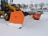 skid steer snow pusher in action