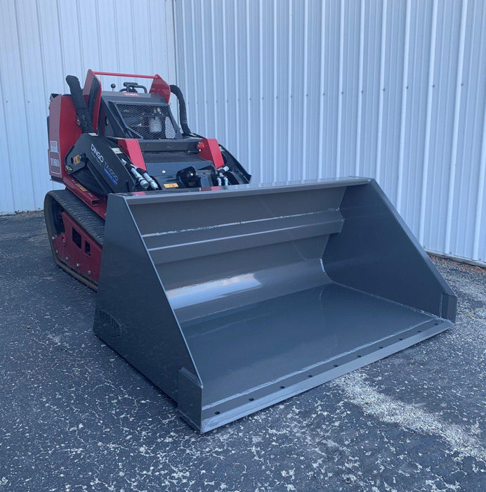 mini skid steer buckets on ground