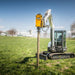 montana post driver mounted on white excavator driving a post