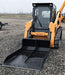 skid steer bucket front view on ground