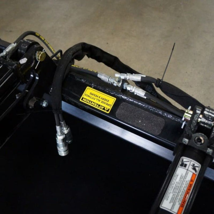 skid steer grapple bucket close up on hydraulic hoses