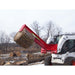 skid steer log splitter on skid steer with wood in the splitter in a field