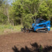 skid steer power rake in field