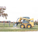 skid steer stump remover in field