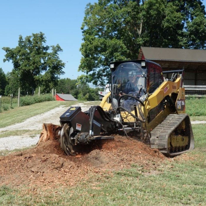 skid steer with stump grinder in action