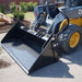 skid steer 4 in 1 bucket attached to skid steer machine