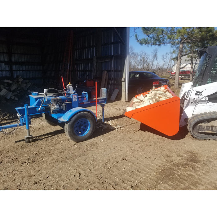 snow bucket skid steer side view loaded with wood from wood splitter