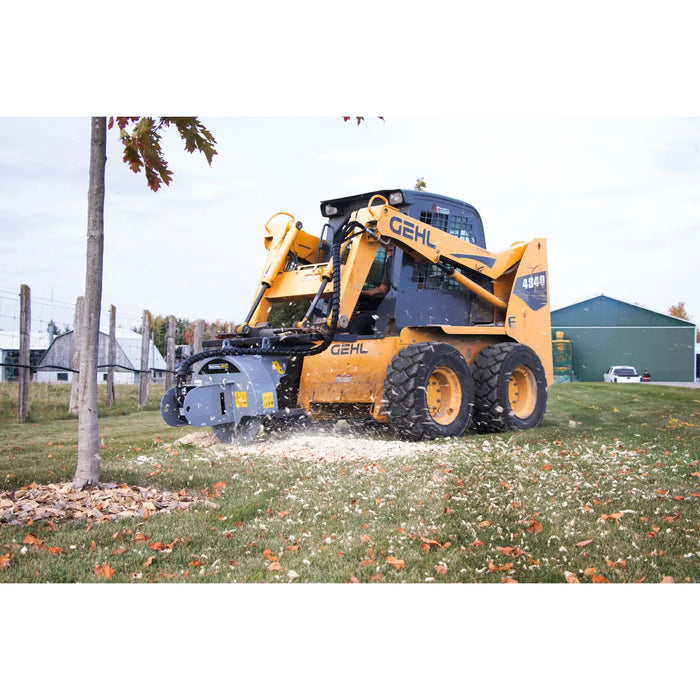 tree grinder for skid steer in use